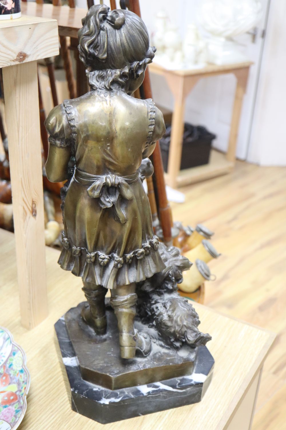 A modern bronze of a girl with a dog and puppies, height 51cm